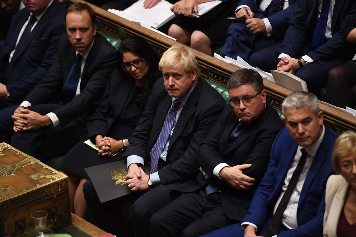 A handout picture released by the UK Parliament shows Britain`s prime minister Boris Johnson (C) sat on the front bench in the House of Commons in London on 22 October during the debate and vote on the Brexit Withdrawal Agreement Bill. Photo: AFP