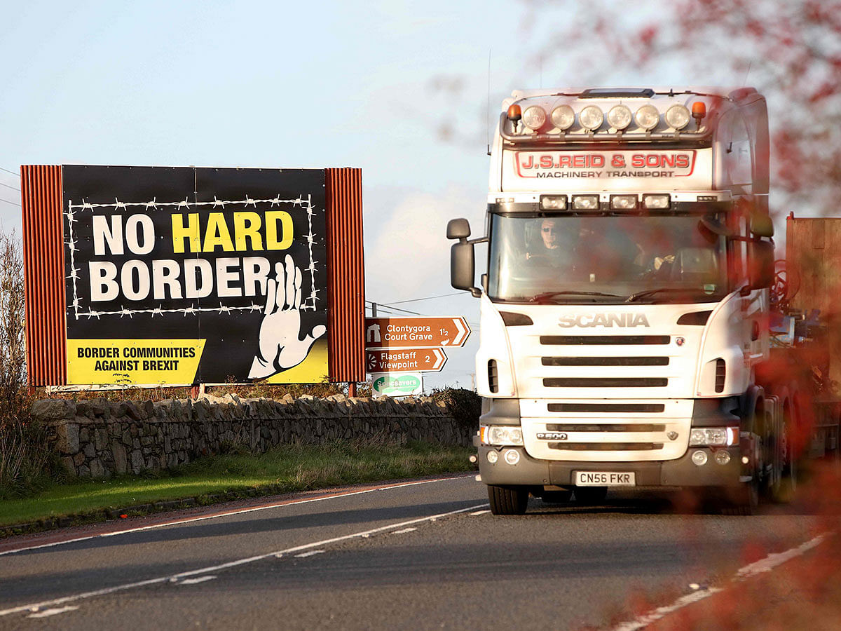 A lorry driver passes an anti-Brexit `No Hard Border` as he drives in Newry, Northern Ireland on 16 October 2019, on the road crossing the border between Newry and Dundalk in Ireland. Photo: AFP
