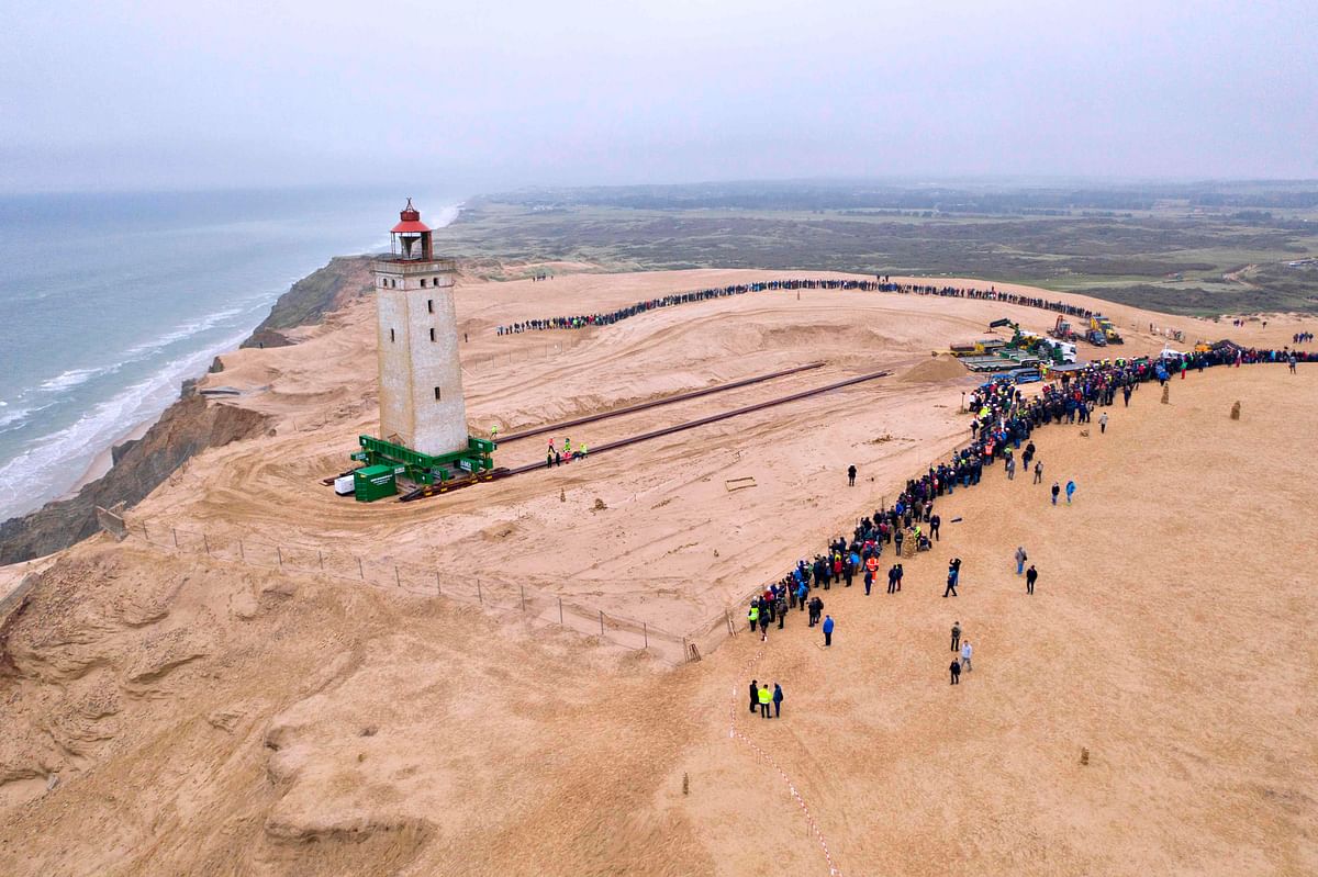 People look on as the lighthouse in Rubjerg Knude is being moved away from the coastline on 22 October 2019 between Lonstrup and Lokken, Jutland, Denmark. Photo: AFP