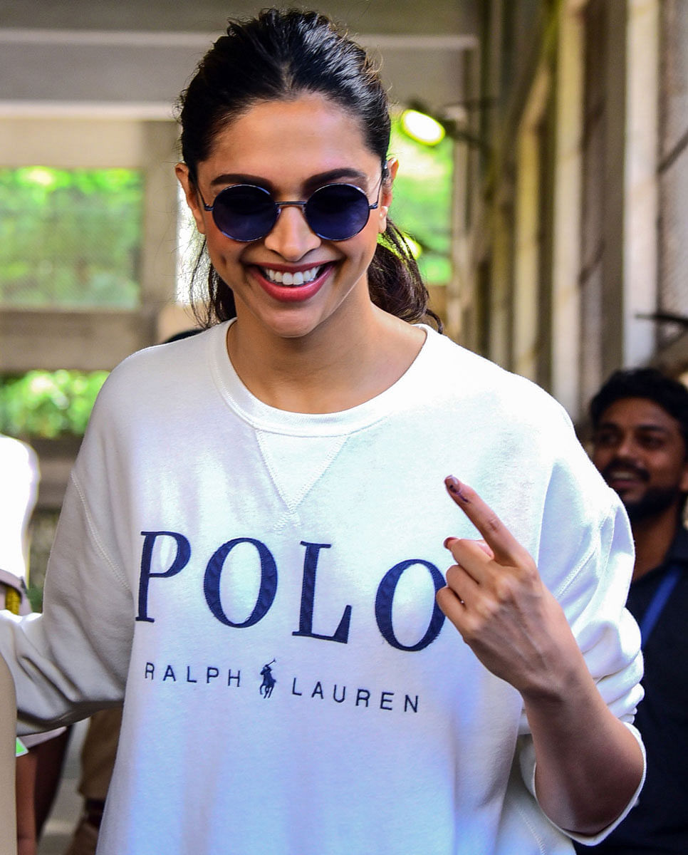 Bollywood actress Deepika Padukone shows her inked finger after casting her vote at a polling station during the state assembly election in Mumbai on 21 October. Photo: AFP