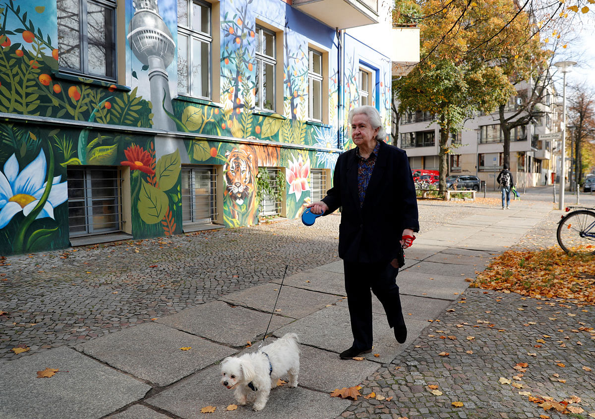 Dagmar Simdorn, an 81-year-old East German pensioner, who lives at Acker Strasse, walks towards the Berlin Wall memorial in Berlin. Photo: AFP