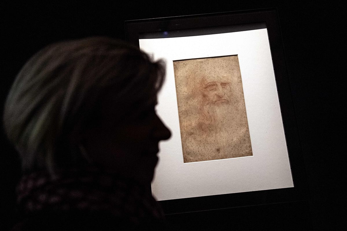In this file photograph taken on 15 April 2019, a visitor views the `Portrait of a man in red chalk` (circa 1510), widely accepted as a self-portrait of Leonardo da Vinci, during the exhibition `Leonardo da Vinci. Photo: AFP