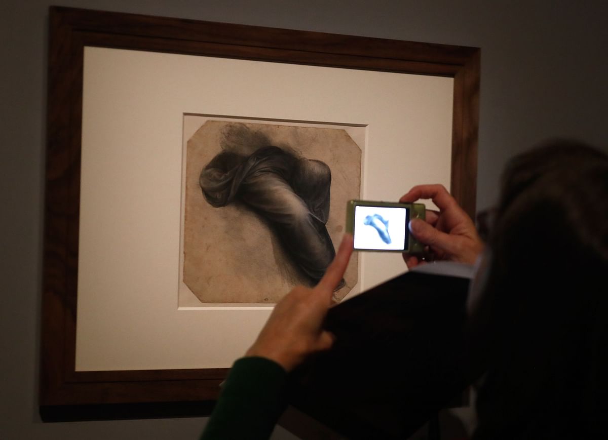 A person take a picture with mobile phone at a drawing by Leonardo da Vinci`s ` Study for the Virgin’s mantle`, during the opening of the exhibition ` Leonardo da Vinci `, on 22 October 2019 at the Louvre museum in Paris. Photo: AFP