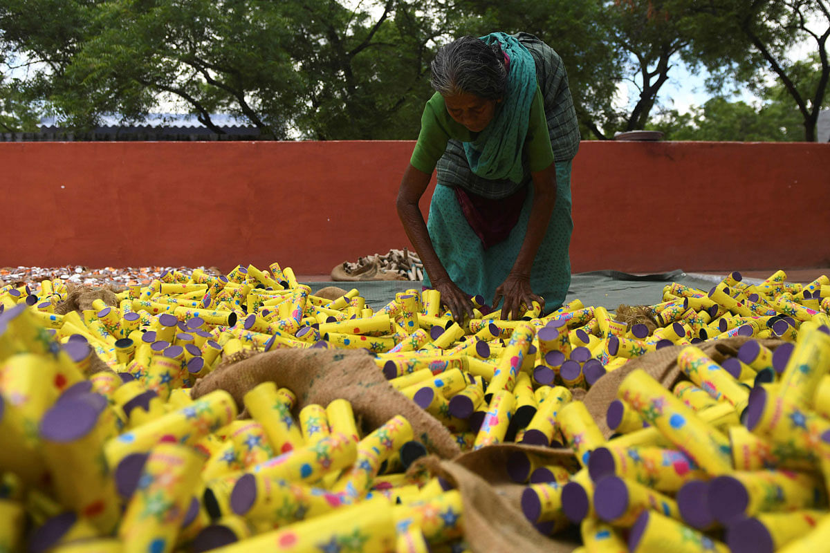 In this photograph taken on 14 October 2019, a worker lays firecrackers in an outdoor yard at a manufacturing unit involved in the production of different varieties of firecrackers ahead of the Hindu festival of Diwali, in Sivakasi. Photo: AFP
