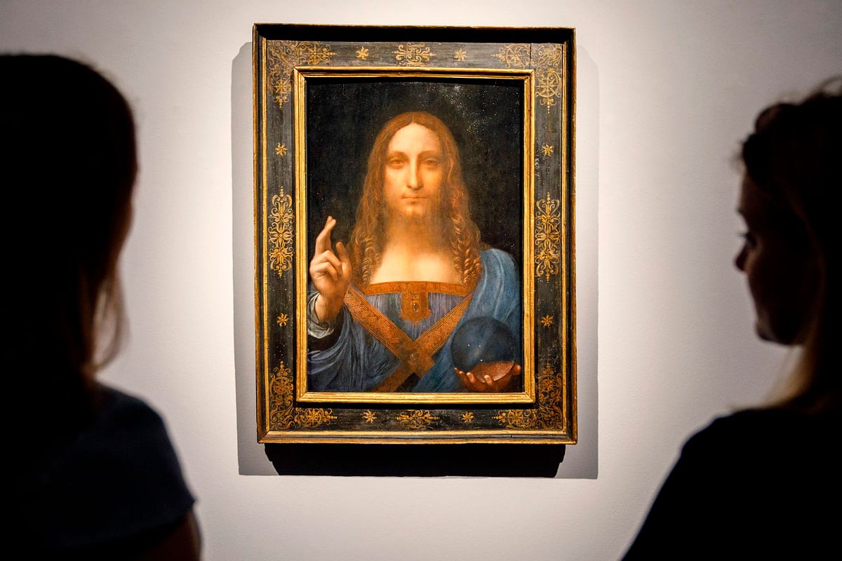 In this file photo taken on 22 October 2017 Christie`s employees pose in front of a painting entitled Salvator Mundi by Italian polymath Leonardo da Vinci at a photocall at Christie`s auction house in central London ahead of its sale at Christie`s New York on 15 November 2017. Photo: AFP