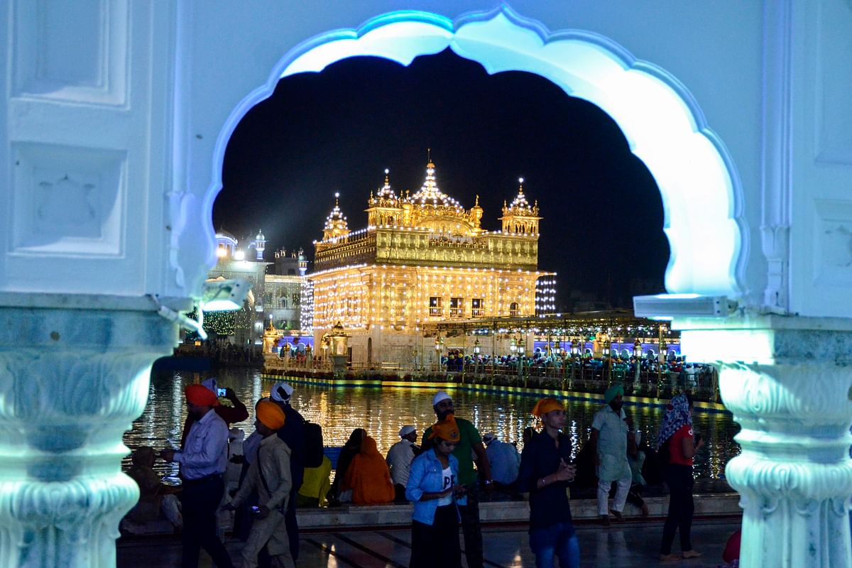 Indian Sikh devotees pay their respects on the eve of `Bandi Chhor Divas` or `Diwali` at the illuminated Golden Temple, in Amritsar on on 26 October 2019. Photo: AFP