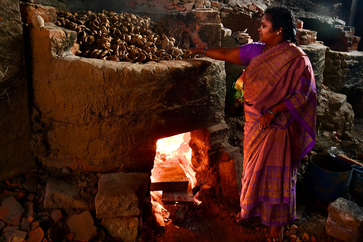 A potter prepares to bake clay oil lamps ahead of Diwali festival, or festival of lights, at Pottery Town in Bangalore on 24 October 2019. Photo: AFP
