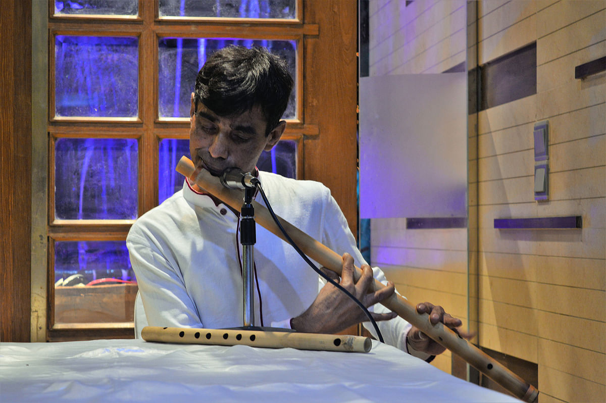 An artiste plays flute to the delight of the guests.