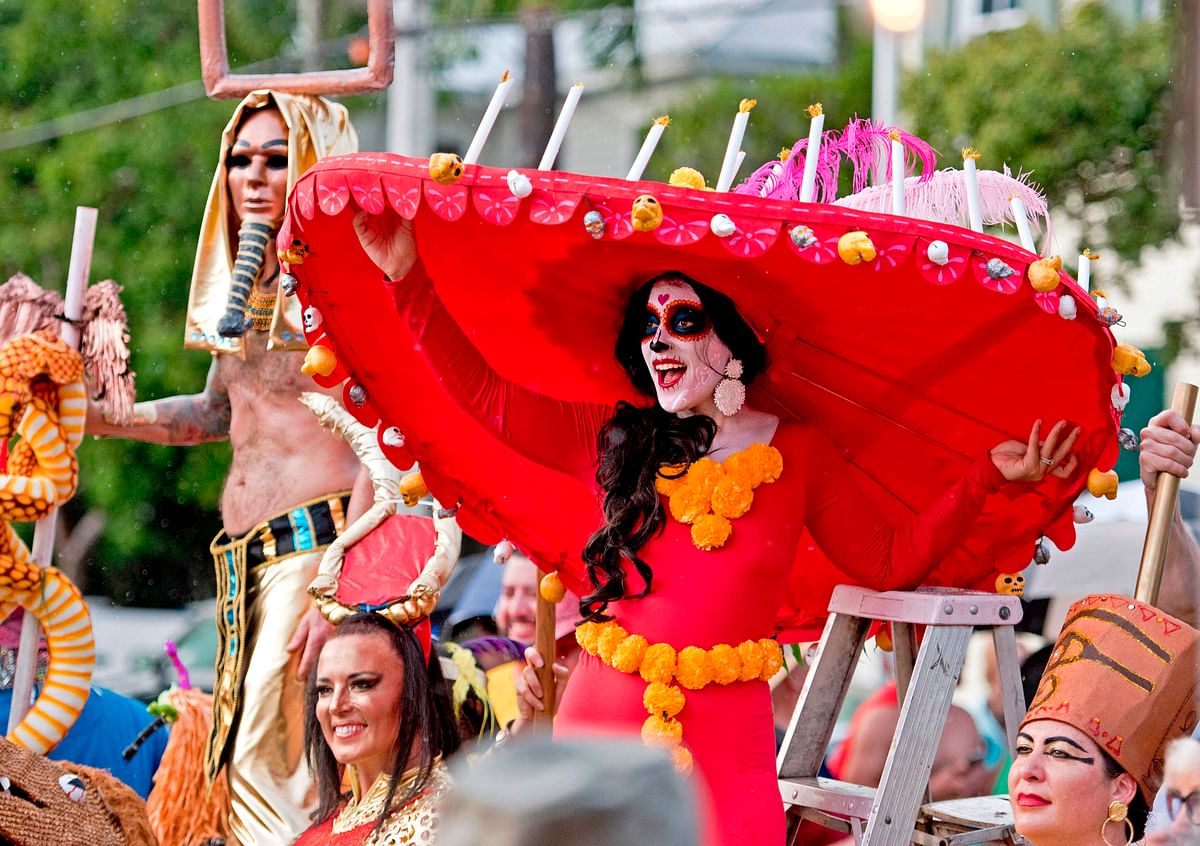 In this photo released by the Florida Keys News Bureau, costumed revelers proceed down Fleming Street on 25 October 2019, in Key West, Florida, during the Fantasy Fest Masquerade March. Photo: AFP
