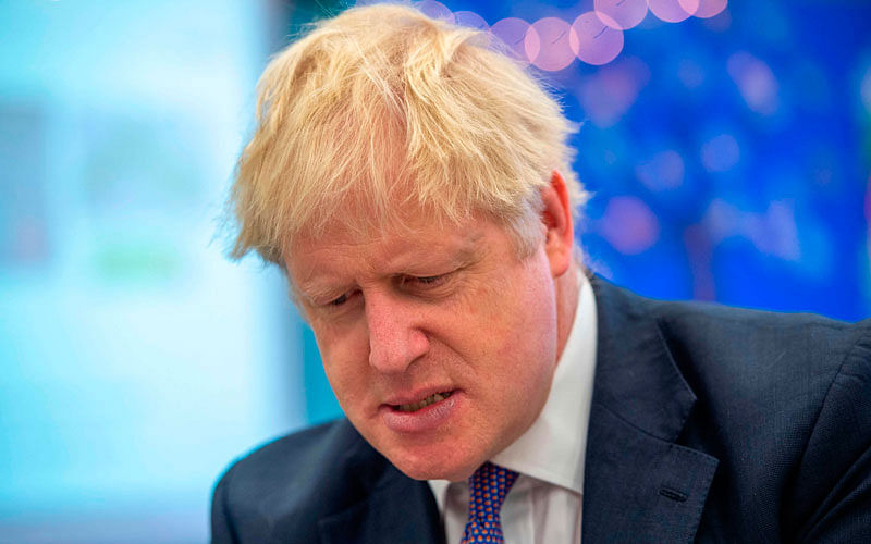 Britain’s prime minister Boris Johnson speaks to pupils as he visits Middleton Primary School in Milton Keynes, southern England on 25 October.Photo: AFP