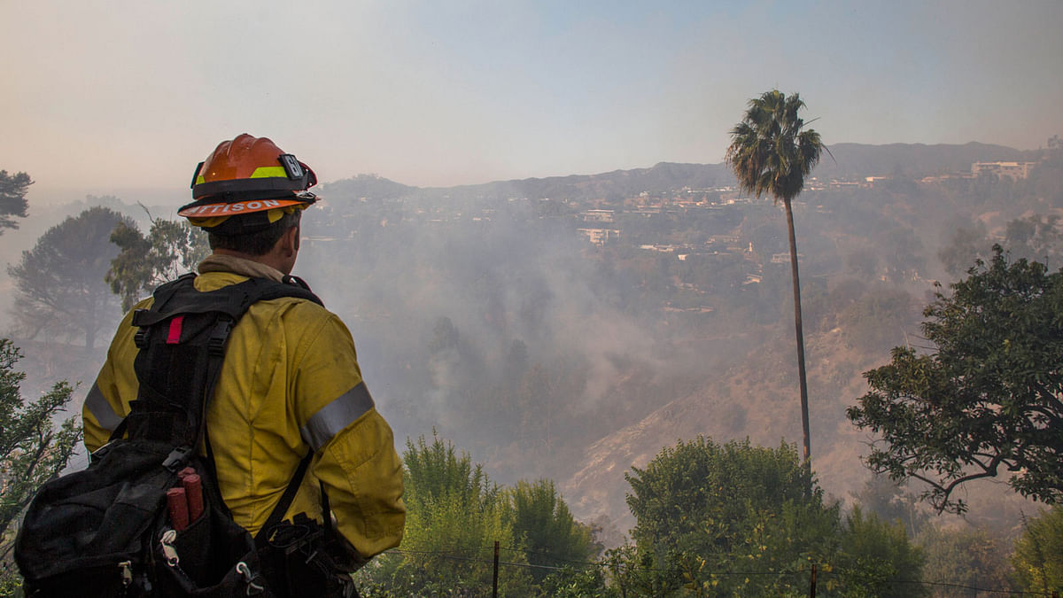 Fire-fighters battle the Getty Fire in houses on fire in Brentwood, California on 28 October. Photo: AFP