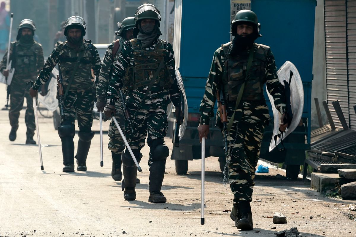 Indian paramilitary troopers patrol along a street during a lockdown in Srinagar on 29 October, 2019. Photo: AFP