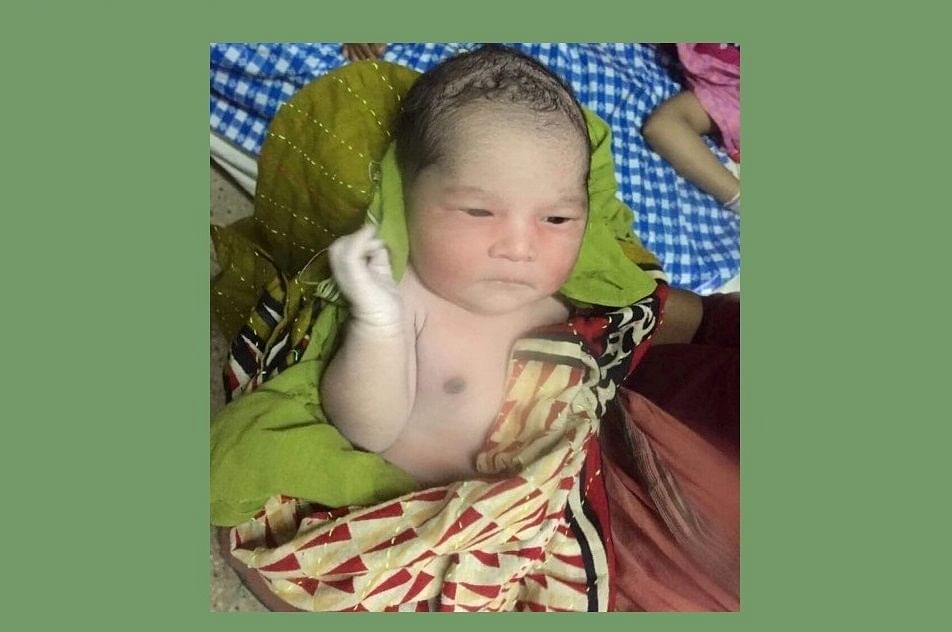 The newborn daughter of convicted Kamrun Nahar Moni. Photo: UNB