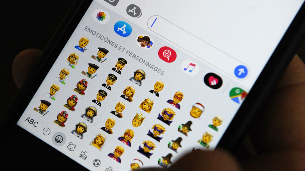 A person holds an iPhone showing emojis in Hong Kong, on 30 October 2019. Apple has put out new gender neutral emojis of most of its people icons -- including punks, clowns and zombies -- as part of an update to its mobile operating system. Photo: AFP
