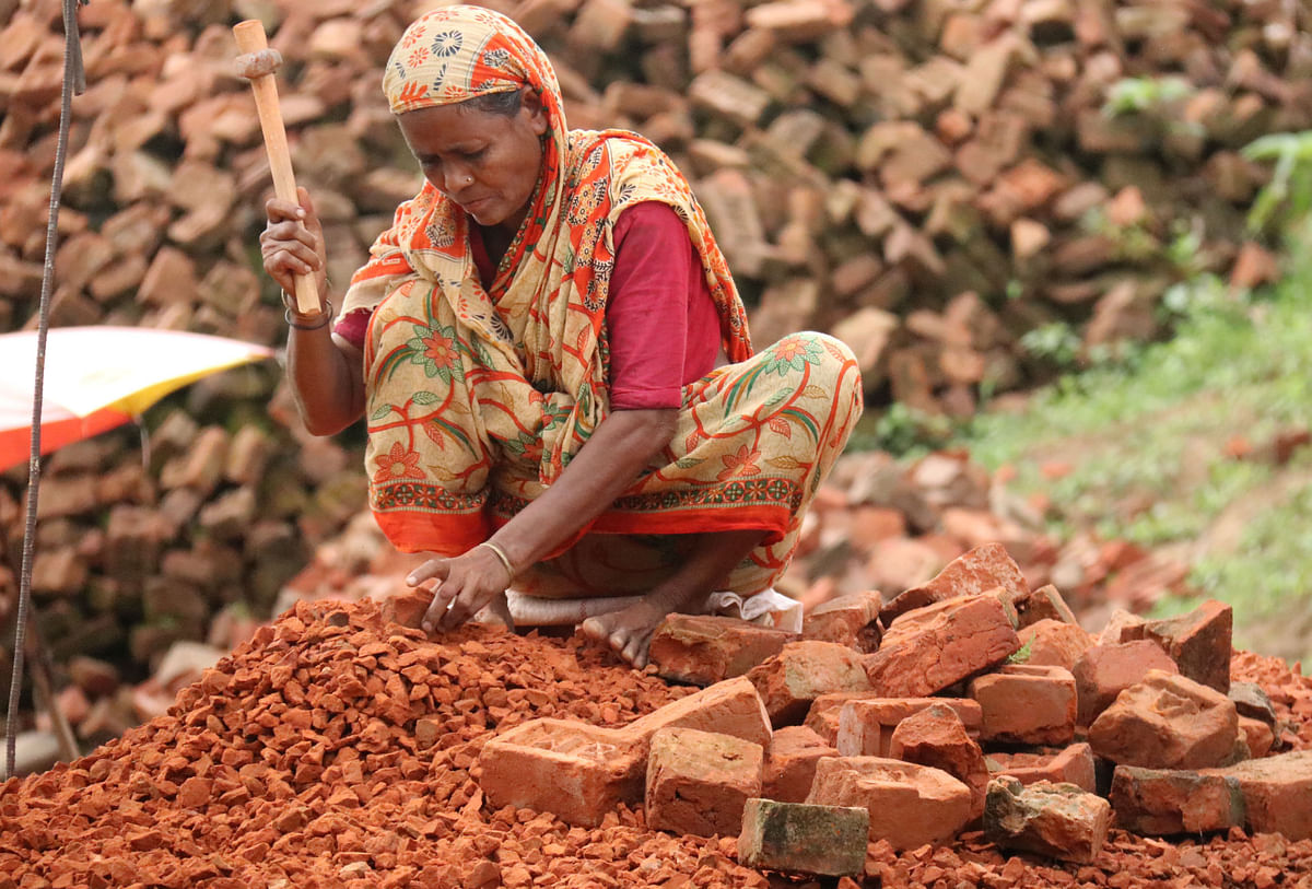 A woman breaks bricks at Zero Mile, Khagrachhari on 29 October 2019. Photo: Nerob Chowdhury