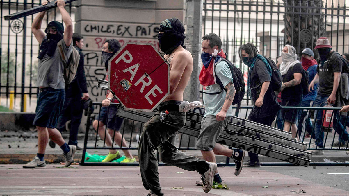 Demonstrators protest violently against the government`s economic policies in Santiago on October 29, 2019. Chilean President Sebastian Pinera unveiled a major cabinet reshuffle on the eve as he battles to find a response to more than a week of street protests that have left at least 20 people dead. Photo: AFP