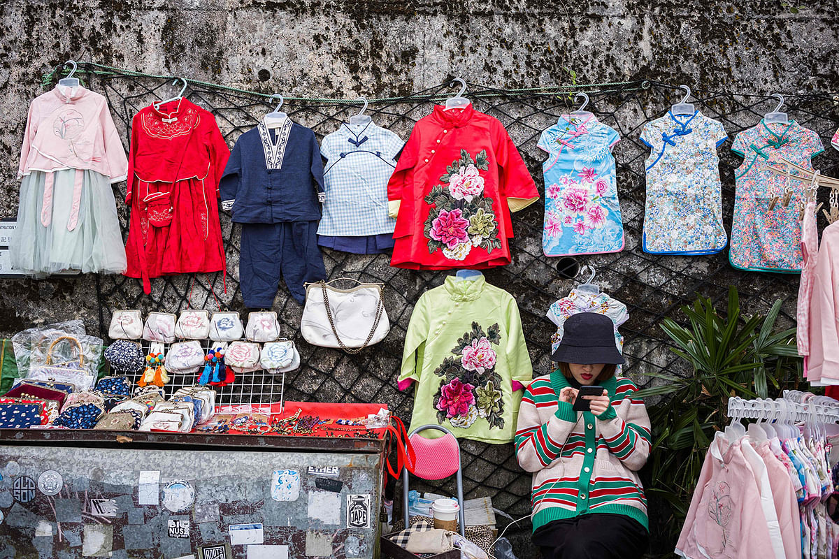 A tourist souvenir vendor waits for customers at her stall on Victoria Peak in Hong Kong on 30 October 2019, a day before the city’s third-quarter gross domestic product (GDP) figures are released. Photo: AFP