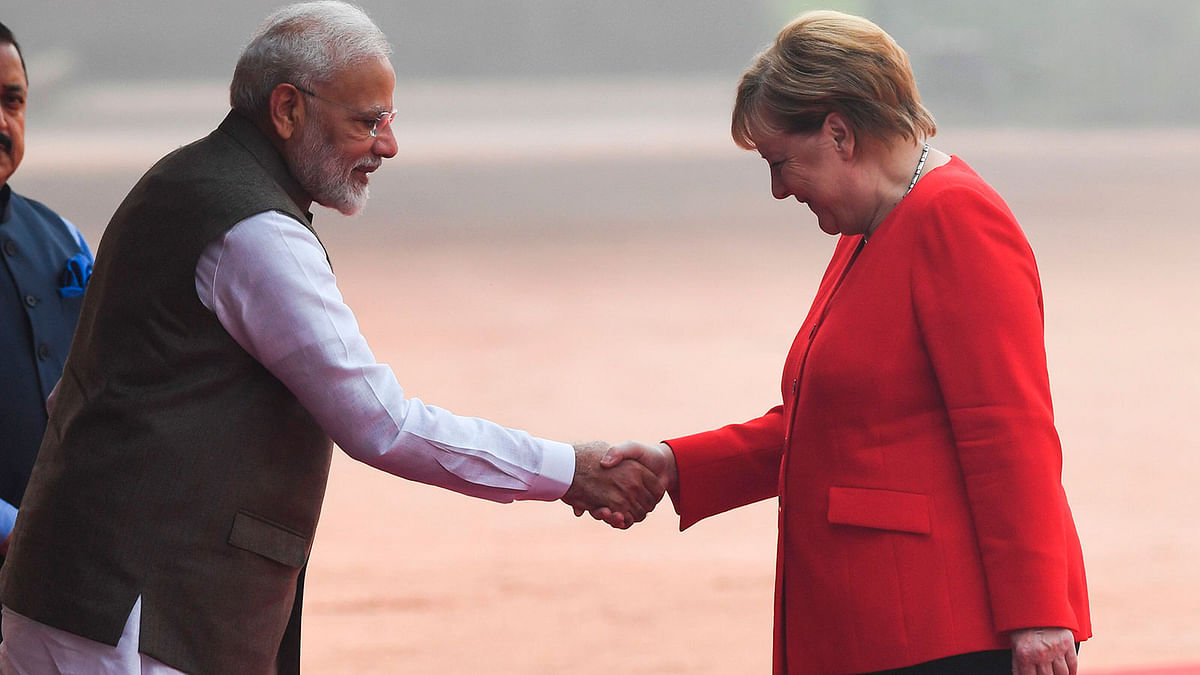 India`s Prime Minister Narendra Modi (L) shakes hands with German Chancellor Angela Merkel during a welcoming ceremony at Rashtrapati Bhavan - The Presidential Palace in New Delhi on 1 November 2019. Photo: AFP