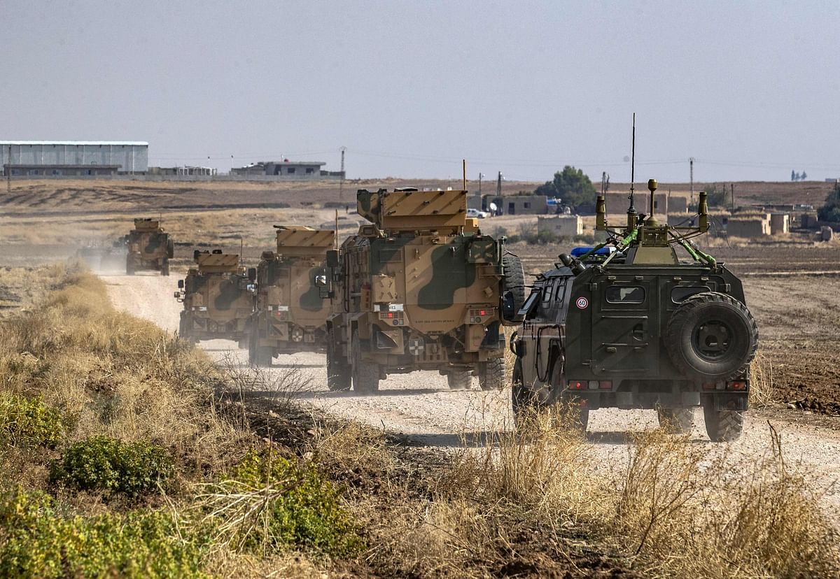 Russian (R) and Turkish military vehicles patrol in the countryside of Darbasiyah town in Syria`s northeastern Hasakeh province on 1 November 2019. Photo: AFP