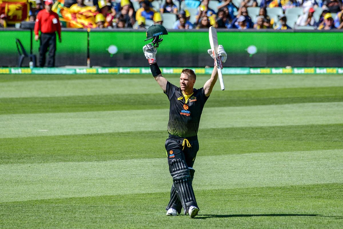 Australian batsman David Warner celebrates his first 100 runs for Australia since his 12 month ban during the first international T20 cricket match between Australia and Sri Lanka at the Adelaide Oval on 27 October 2019. Photo: AFP