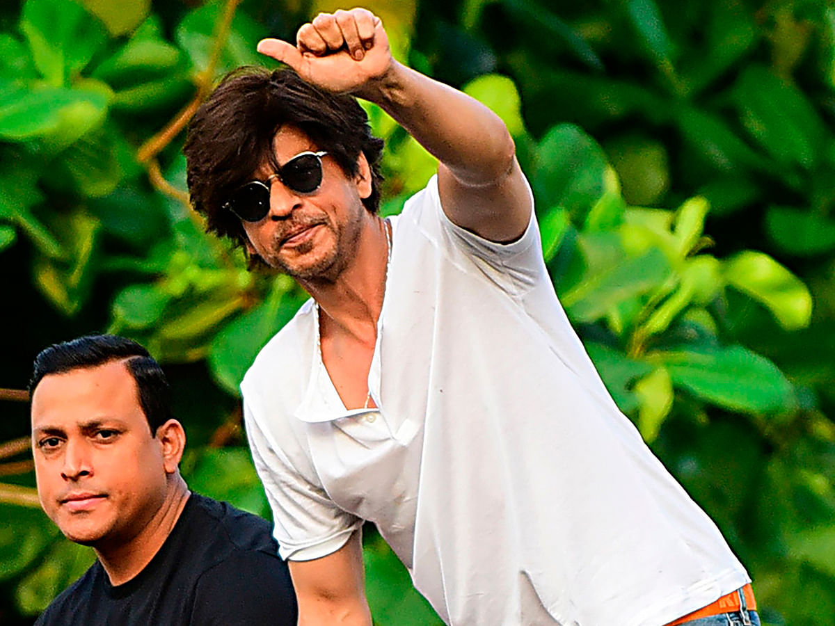 Bollywood actor and producer Shah Rukh Khan gestures towards fans during celebrations for his 54th birthday at his home in Mumbai on 2 November, 2019. Photo: AFP