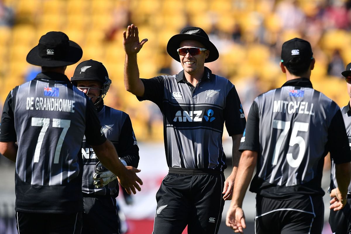 New Zealand`s captain Tim Southee (C) celebrates with Colin de Grandhomme (L) after taking the wicket of England`s Sam Billings during the Twenty20 cricket match between New Zealand and England at Westpac Stadium in Wellington on 3 November 2019. Photo: AFP