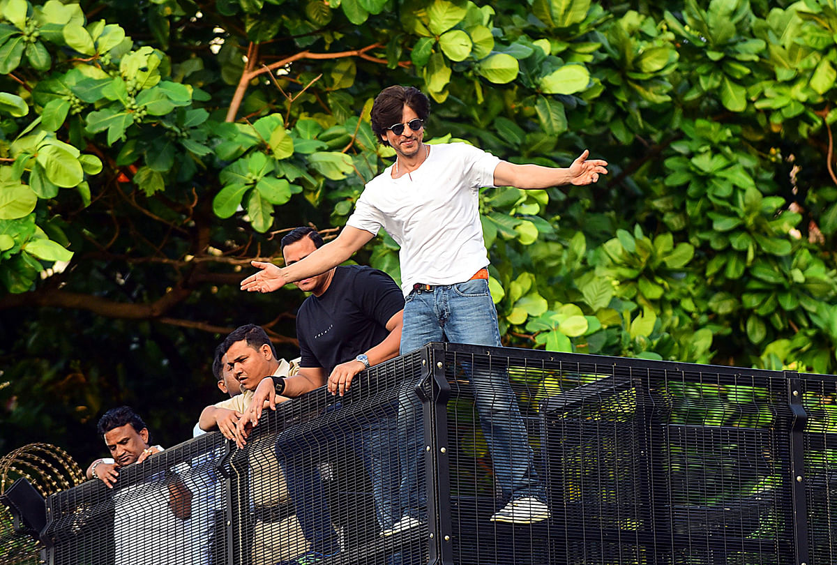 Bollywood actor and producer Shah Rukh Khan gestures towards fans during celebrations for his 54th birthday at his home in Mumbai on 2 November, 2019. Photo: AFP