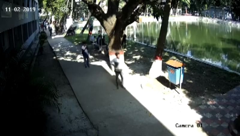 A video grab of CCTV footage that shows a group of ‘BCL activists’ threw Rajshahi Polytechnic Institute principal Farid Uddin Ahmed into a pond on the campus on Saturday. Photo: UNB