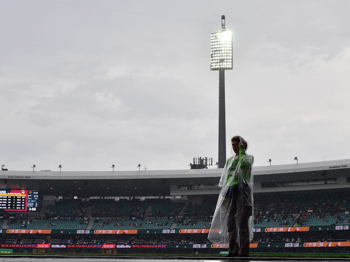 A volunteer is seen as the Twenty20 cricket match between Australia and Pakistan is halted due to rain at the Sydney Cricket Ground in Sydney on 3 November 2019. Photo: AFP