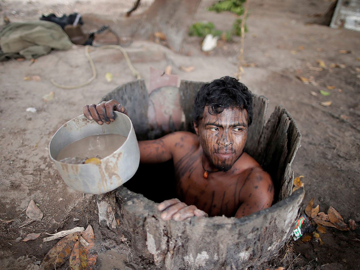 Paulo Paulino Guajajara was hunting on Friday Nov 1 inside the Arariboia reservation in Maranhao state when he was attacked and killed by illegal loggers. He was an indigenous Indian `forest guardian,` seen here drawing water from a well at a loggers camp on Arariboia indigenous land near the city of Amarante, Maranhao state, Brazil, 11 September 2019. Photo: Reuters