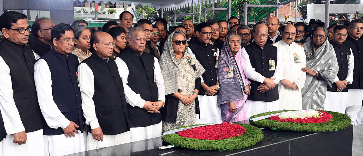 Prime minister Sheikh Hasina and other party leaders stand in solemn silence in front of the portrait father of the nation Bangabandhu Sheikh Mujibur Rahman at the Bangabandhu Memorial Museum in Dhanmondi, Dhaka on Sunday marking the Jail Killing Day. Photo: PID