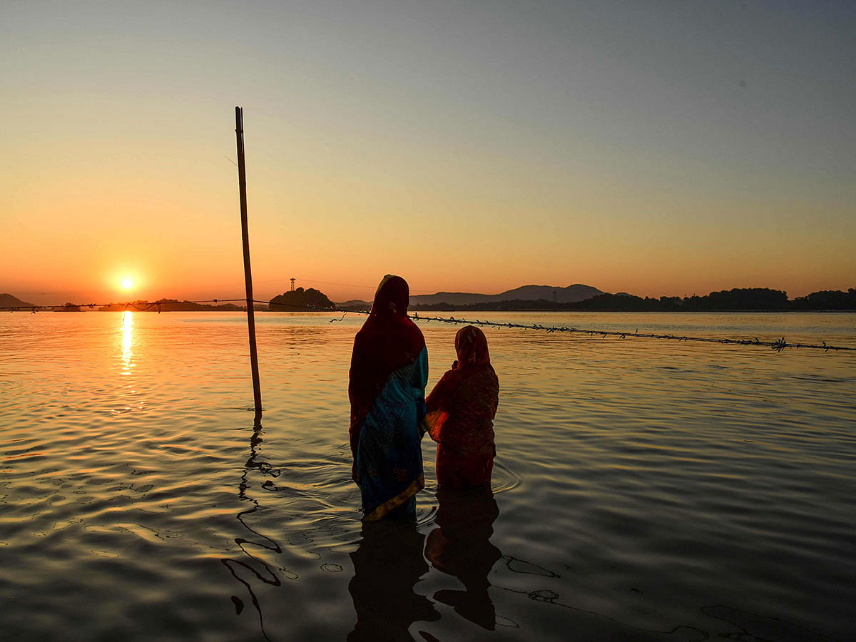 Hindu devotees offer prayers during the Chhat Puja Festival on the banks of the Brahmaputra river in Guwahati on 2 November 2019. Photo: AFP
