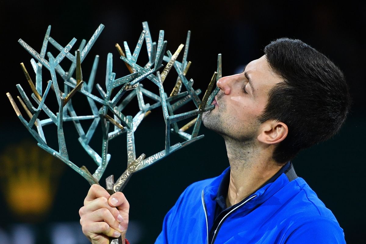 Winner Serbia`s Novak Djokovic kisses his trophy after winning against by Canada`s Denis Shapovalov during their men`s singles final tennis match at the ATP World Tour Masters 1000 - Rolex Paris Masters - indoor tennis tournament at The AccorHotels Arena in Paris on 3 November 2019. Photo: AFP
