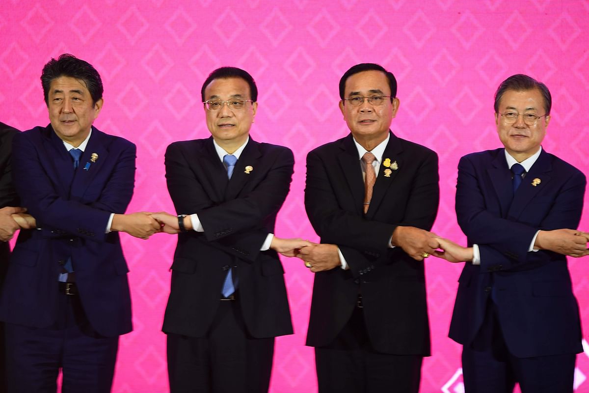 Japan`s prime minister Shinzo Abe, China`s premier Li Keqiang, Thailand`s prime minister Prayut Chan-O-Cha and South Korea`s president Moon Jae-in pose for a group photo during the 22nd ASEAN Plus Three Summit in Bangkok on 4 November. Photo: AFP