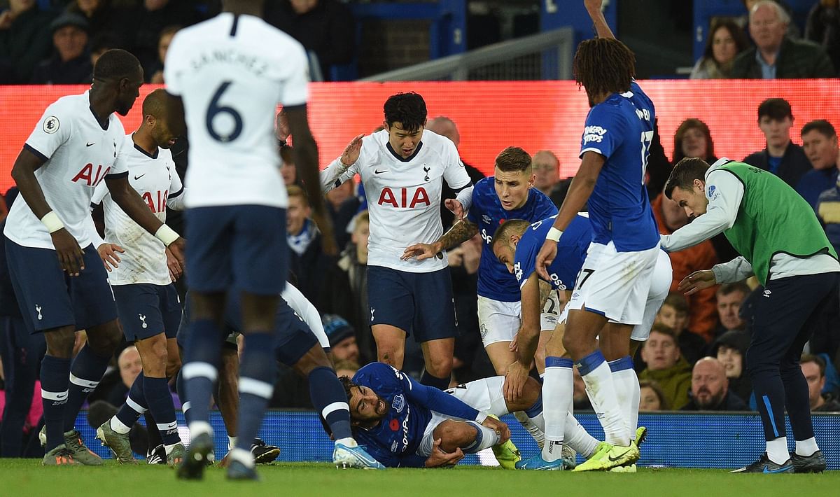 Everton`s Portuguese midfielder André Gomes (C floor) reacts to an injury to his leg during the English Premier League football match between Everton and Tottenham Hotspur at Goodison Park in Liverpool, north west England on 3 November 2019. Photo: AFP