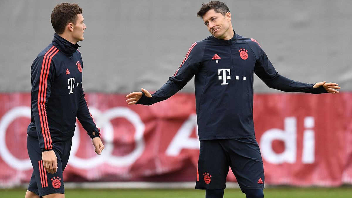 Bayern Munich`s French defender Benjamin Pavard (L) and Bayern Munich`s Polish forward Robert Lewandowski talk together during a training session on the eve of the UEFA Champions League Group B football match between FC Bayern Munich and Olympiakos in Munich, southern Germany, on Tuesday. Photo: AFP