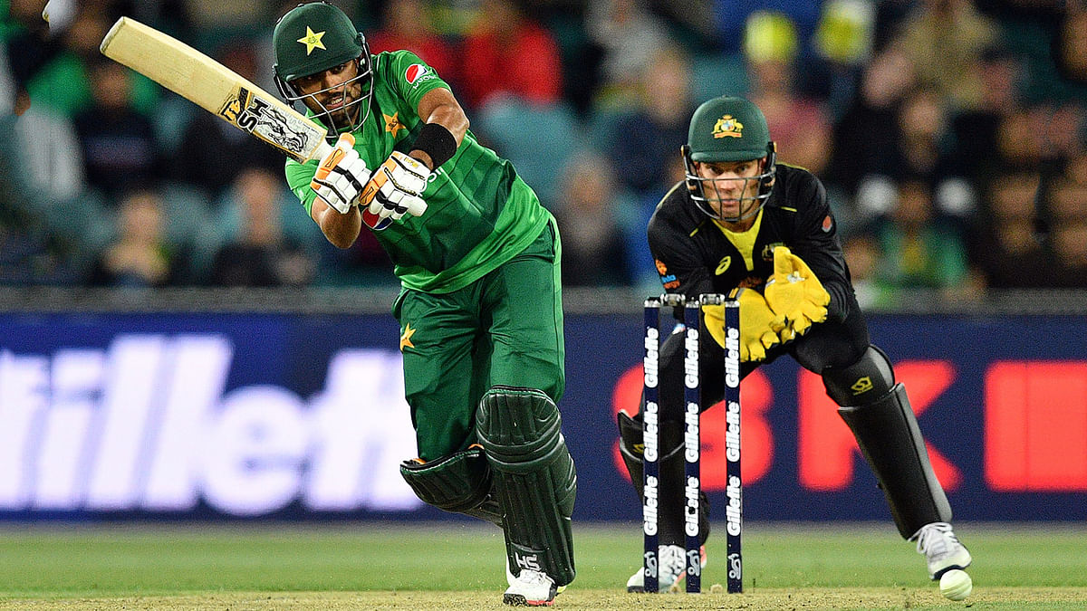 Pakistan`s Babar Azam plays a shot as Australia`s wicketkeeper Alex Carey (R) looks on during the second Twenty20 match between Australia and Pakistan at the Manuka Oval in Canberra on 5 November, 2019. Photo: AFP