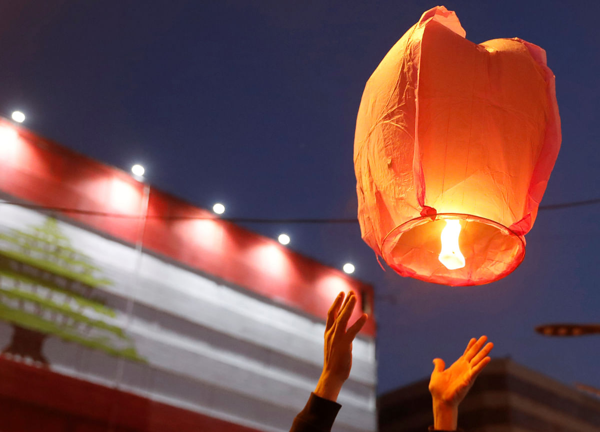A demonstrator releases a sky lantern during a protest in Tripoli, Lebanon on 2 November 2019. Photo: Reuters
