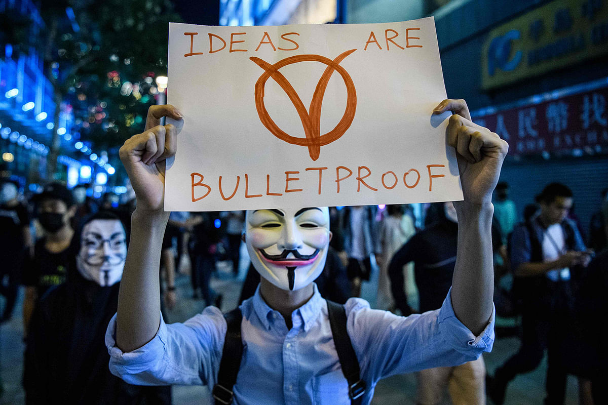 Protesters wearing a Guy Fawkes mask - after the British Catholic rebel who attempted to blow up parliament in the fifteenth century - gather in the Kowloon district of Hong Kong on 5 November 2019, to mark the one month anniversary of the local government banning face coverings at rallies. Photo: AFP