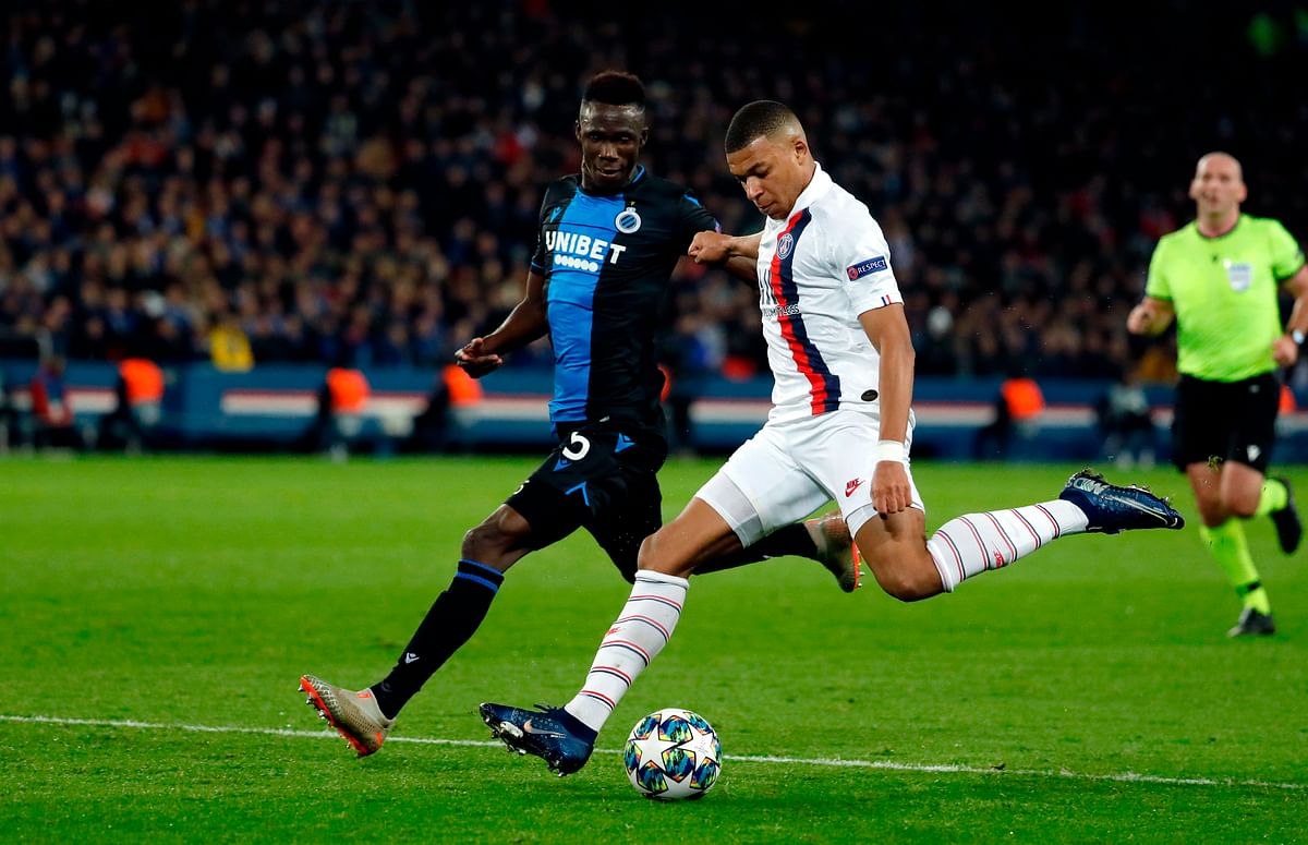 Club Brugge`s Ivorian defender Odilon Kossounou (L) fights for the ball with Paris Saint-Germain`s French forward Kylian Mbappe during the UEFA Champions League Group A football match between Paris Saint-Germain (PSG) and Club Brugge at the Parc des Princes stadium in Paris on 6 November 2019. Photo: AFP