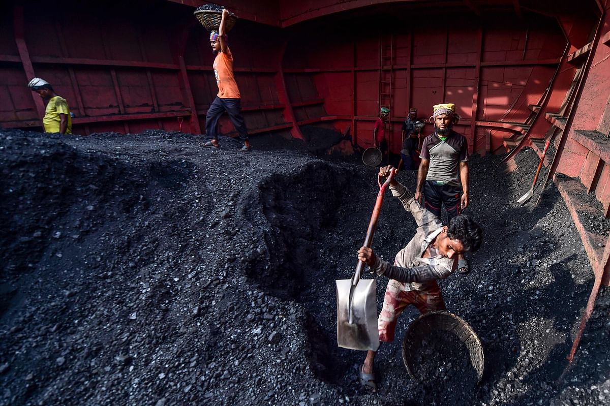 Labourers unload coal from a cargo ship in Gabtoli on the outskirts of Dhaka on 6 November 2019. Photo: AFP