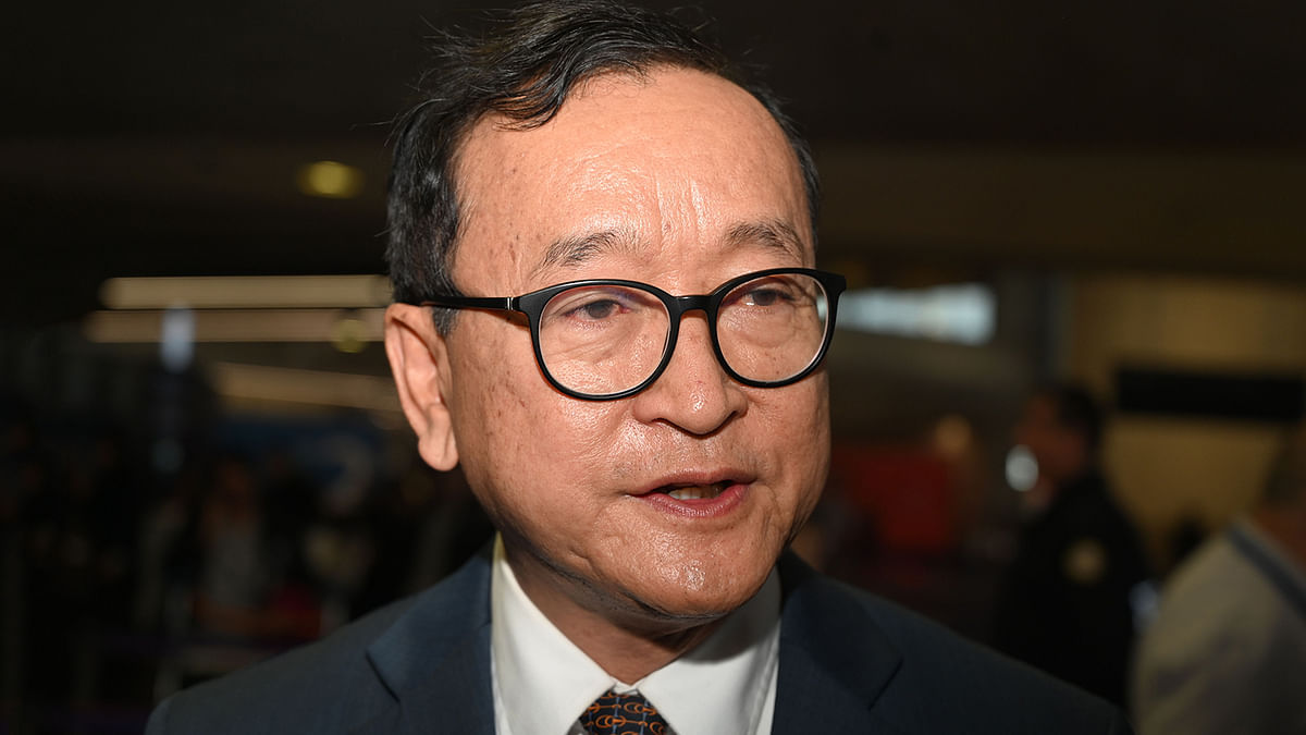 Cambodian opponent in exile and leader of the Cambodia National Rescue Party (CNRP) Sam Rainsy talks at the Roissy-Charles de Gaulle airport, north of Paris on Thursday, during his failed attempt to board a plane for Bangkok after he planned to return to Phnom Penh for Cambodia`s independence day. Photo: AFP
