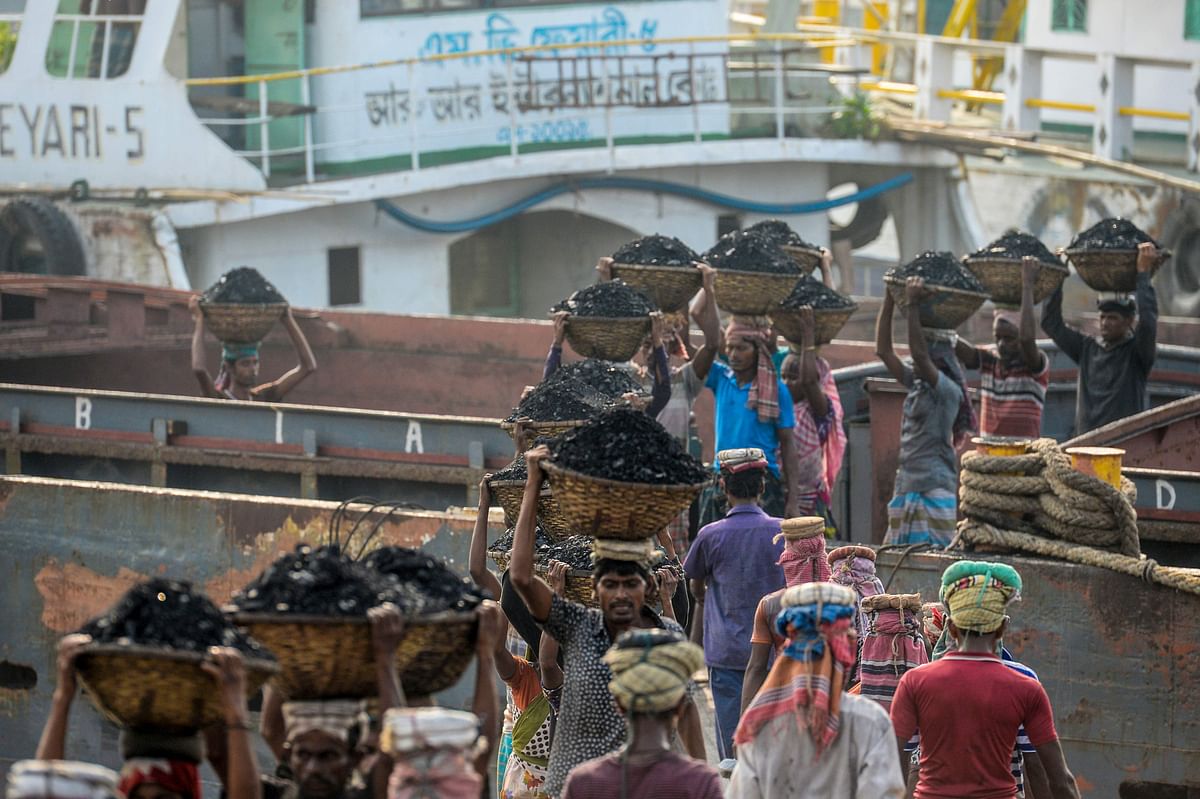 3Labourers unload coal from a cargo ship in Gabtoli on the outskirts of Dhaka on 6 November 2019. Photo: AFP