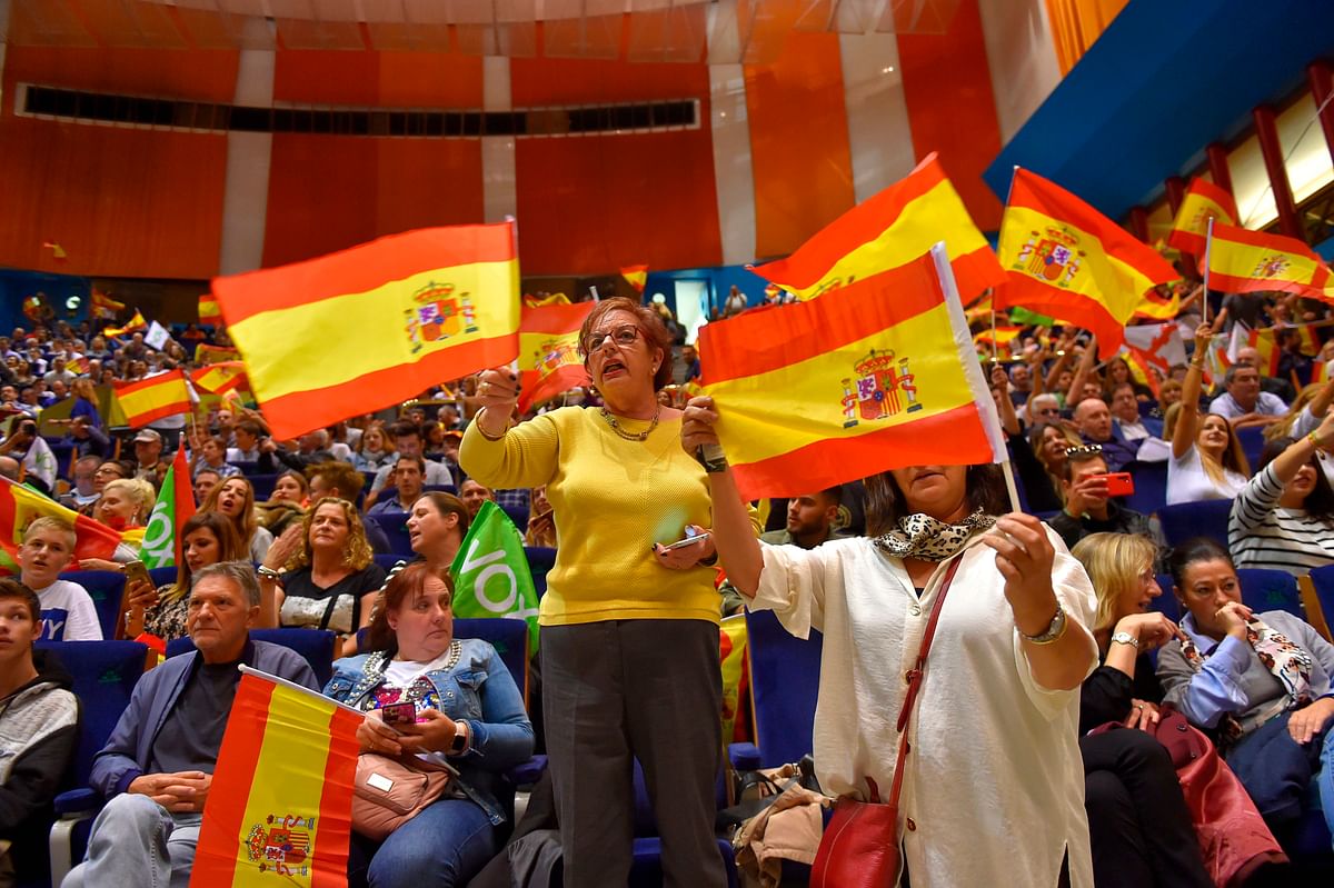 Spanish far-right Vox supporters wave Spanish flags during a campaign rally in Santander, on 1 November ahead of the 10 November general elections. Photo: AFP