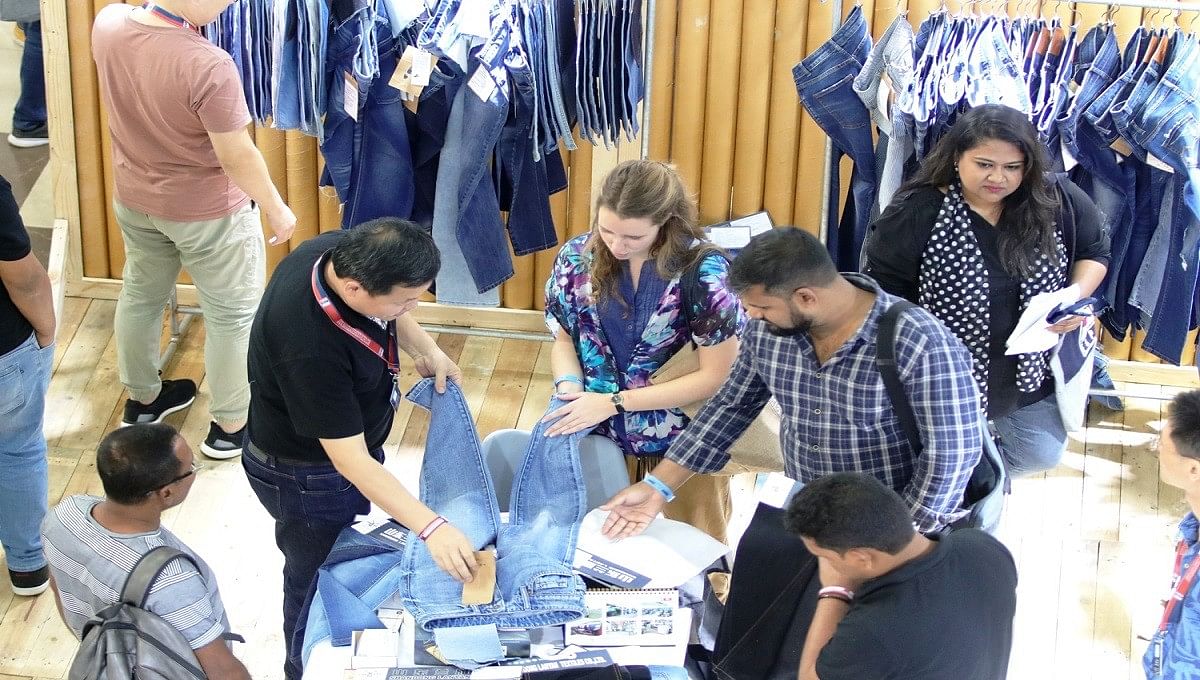 Visitors inspect clothes at Bangladesh Denim Expo on 6 November 2019. Photo: UNB
