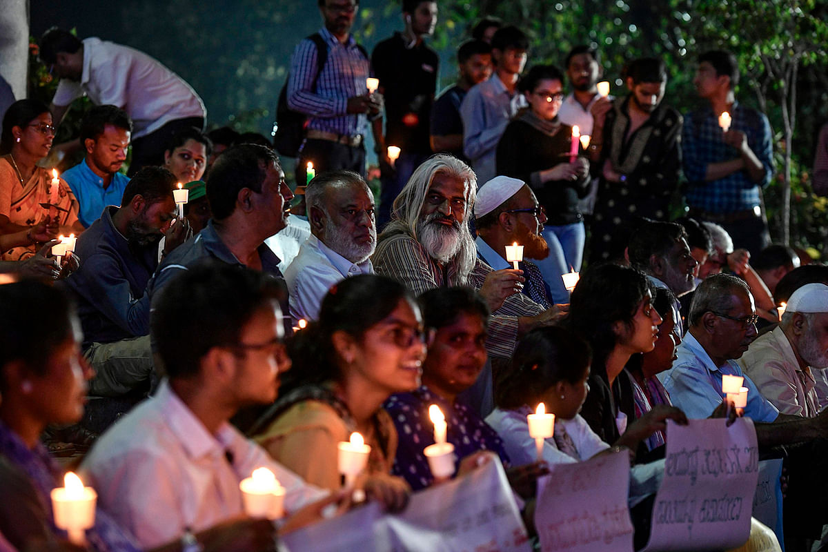 Activists belonging to `People for Peace and Justice` stage a candle light vigil urging people belonging to all religious communities to maintain peace and harmony regardless of the outcome of the Supreme Court verdict on Ayodhya’s Ram Janmabhoomi case, in Bangalore on 7 November 2019. Photo: AFP