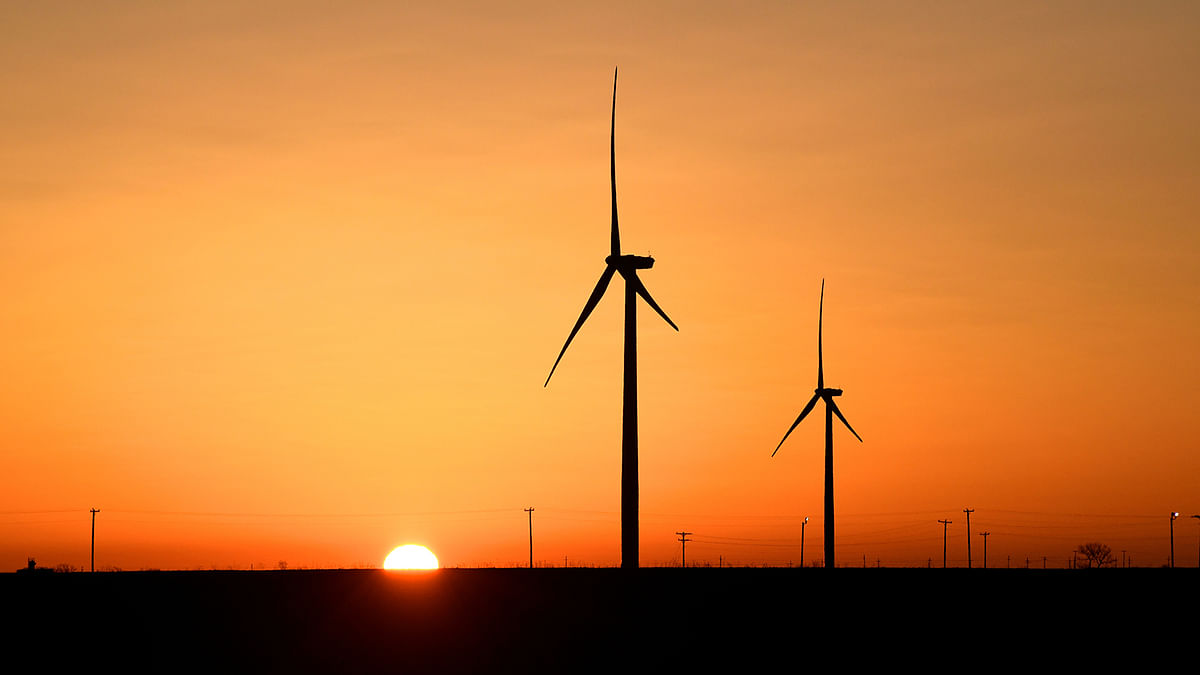 Wind turbines operate at sunrise in the Permian Basin oil and natural gas production area in Big Spring. Photo: Reuters