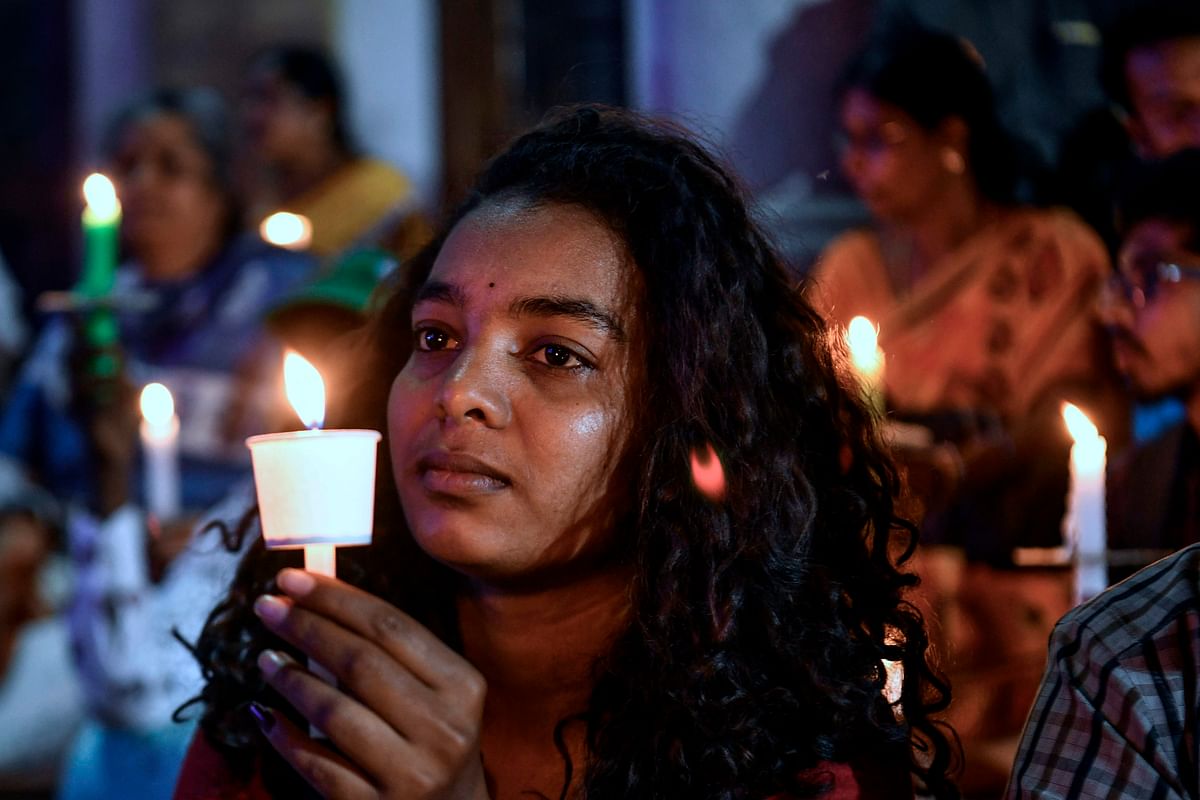 An activist belonging to 'People for Peace and Justice' participates in a candle light vigil urging people belonging to all religious communities to maintain peace and harmony regardless of the outcome of the Supreme Court verdict on Ayodhya’s Ram Janmabhoomi case, in Bangalore on 7 November, 2019. Photo: AFP