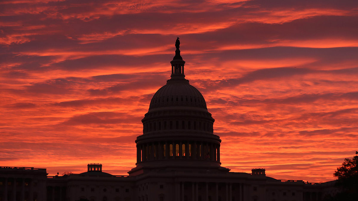 The sky turns to a fiery color as the sun begins to rise behind the U.S. Capitol building, on 7 November 2019 in Washington, DC. Chairman of the House Intelligence Committee, Adam Schiff (D-CA) announced that public hearings will begin next week in the impeachment inquiry against US president Donald Trump. Photo: AFP