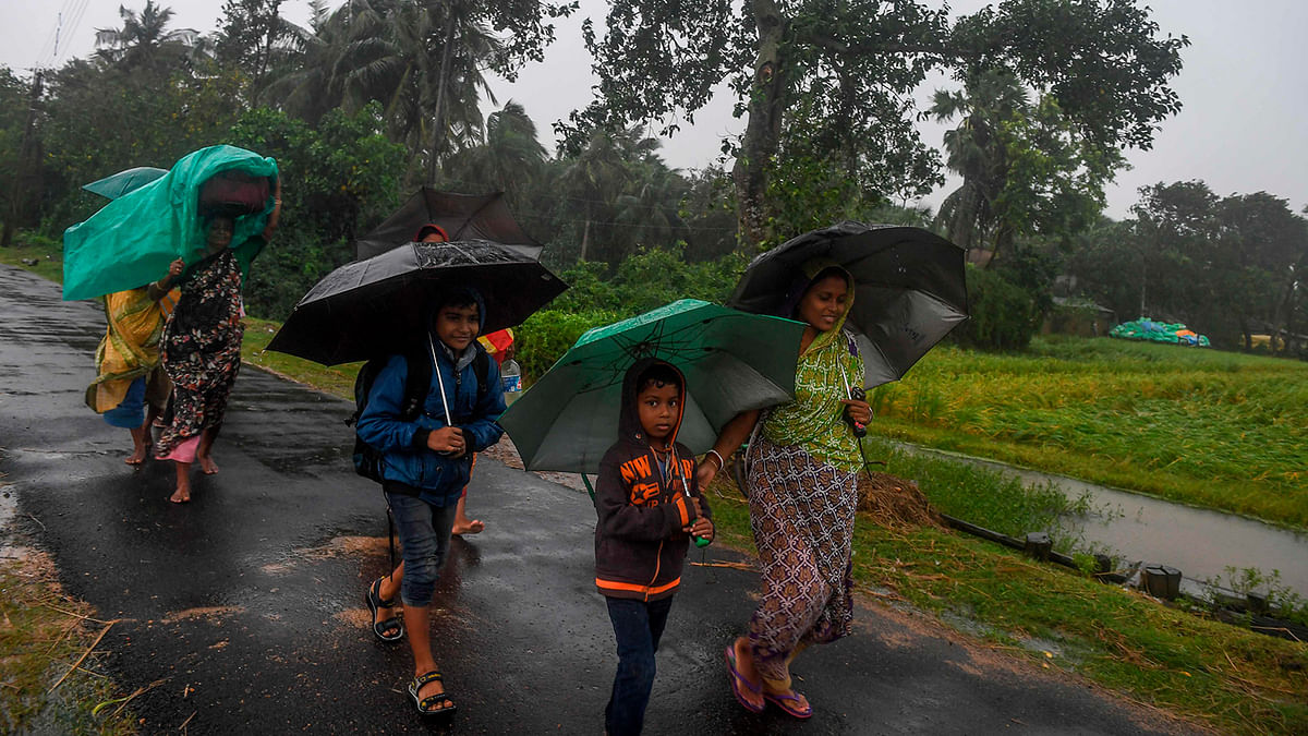 Villagers holding umbrellas carry their belongings on their way to enter a relief centre as Cyclone Bulbul is approaching, in Bakkhali near Namkhana in Indian state of West Bengal on 9 November, 2019. Photo: AFP